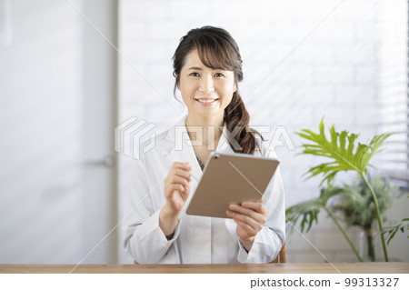 Smiling female doctor looking at camera 99313327