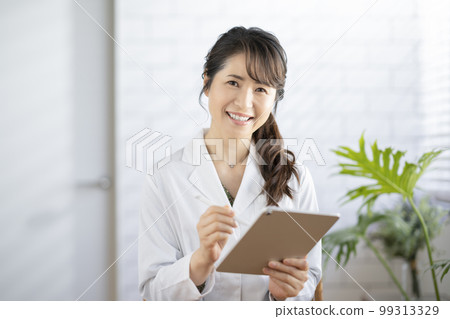 Smiling female doctor looking at camera 99313329