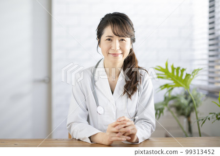Smiling female doctor looking at camera Smiling female doctor looking at camera 99313452