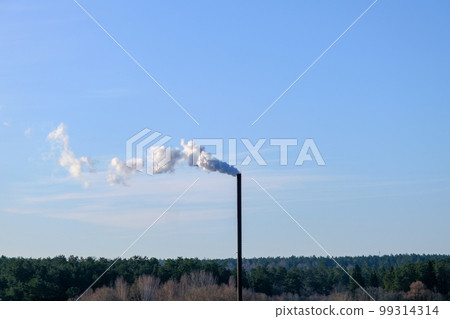 A smoldering factory chimney. Tall metallic smoke stack of incinerator Thick white smoke clouds against blue sky. A smoldering factory chimney. Tall metallic smoke stack of incinerator Thick white smoke clouds against blue sky. 99314314