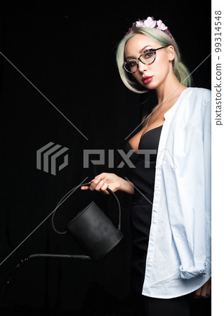 Beautiful woman in shirt with black watering can. Health, cyctitis, disease, pain concept Beautiful woman in shirt with black watering can. Health, cyctitis, disease, pain concept 99314548