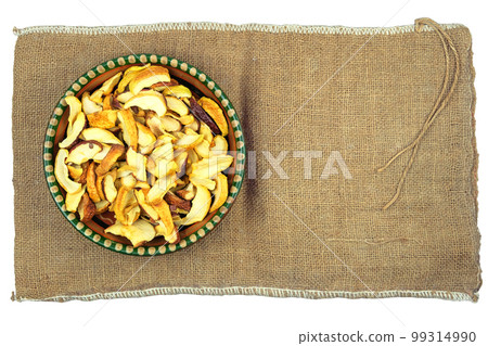 Wheat in a clay plate stands on a rural bag. Vegetarian organic foods.Top view. Wheat in a clay plate stands on a rural bag. Vegetarian organic foods.Top view. 99314990