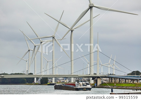 Wind tubines along the waterside 99315559