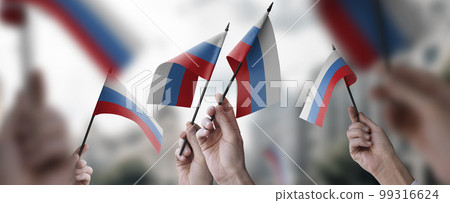 A group of people holding small flags of the Russia in their hands 99316624