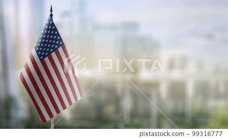 Small flags of the USA on an abstract blurry background 99316777