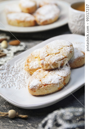 Ricciarelli, gluten free almond cookies. Italian traditional Christmas cookies and coffee. New year decor Ricciarelli, gluten free almond cookies. Italian traditional Christmas cookies and coffee. New year decor 99317237