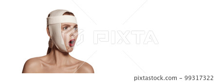 Female face bandaged with medical bandages human emotions. Making beauty, modifying face to make surgical correction, plastic surgery. correction of asymmetry. 99317322