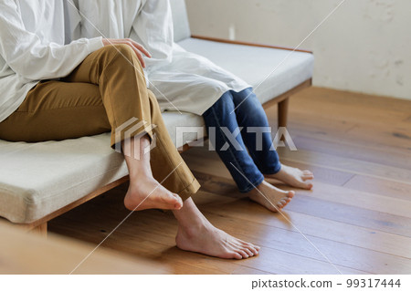 Men and women relaxing on the sofa Parts cut 99317444
