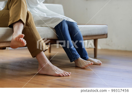 Men and women relaxing on the sofa Parts cut 99317456