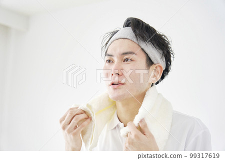 一個男人用毛巾擦汗 白色背景 99317619