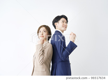 Business woman and businessman in a guts pose white background 99317634