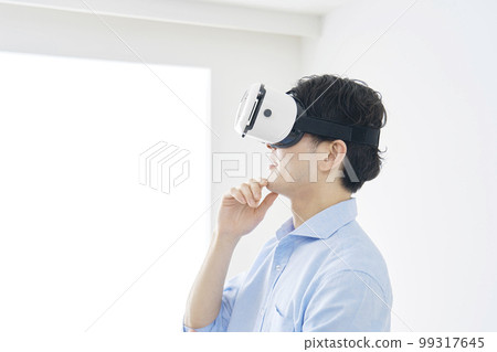 A man thinking with VR goggles 99317645