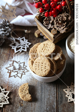 New Year baking. Homemade crispy oatmeal cookies. Rustic style, new year decoration New Year baking. Homemade crispy oatmeal cookies. Rustic style, new year decoration 99319016