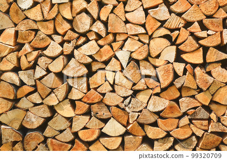 Firewood background. Preparation of firewood for the winter. Pile of firewood. 99320709