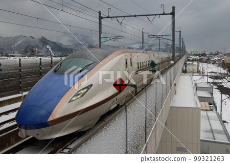 Hokuriku Shinkansen E7 series arriving at Itoigawa station in winter Hokuriku Shinkansen E7 series arriving at Itoigawa station in winter 99321263