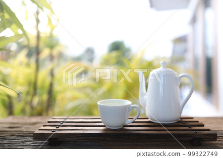 White tea pot and tea cup White tea pot and tea cup 99322749