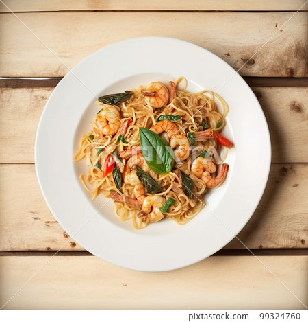 Fried spicy Thai-style seafood spaghetti on a white plate, on a wooden background. Fried spicy Thai-style seafood spaghetti on a white plate, on a wooden background. 99324760