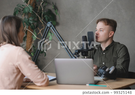 man and woman in studio record podcast, create audio content, advertising message man and woman in studio record podcast, create audio content, advertising message 99325148