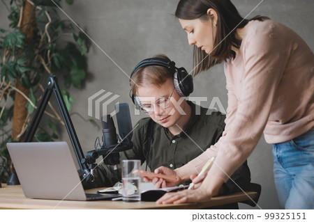 man and woman in studio record podcast, create audio content, advertising message. man and woman in studio record podcast, create audio content, advertising message. 99325151