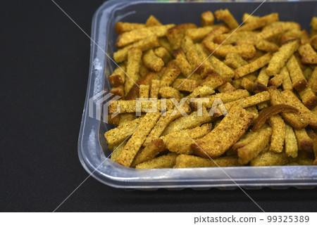 Breadcrumbs in a box. Bread snack for beer. Dried baked bread. Breadcrumbs in a box. Bread snack for beer. Dried baked bread. 99325389