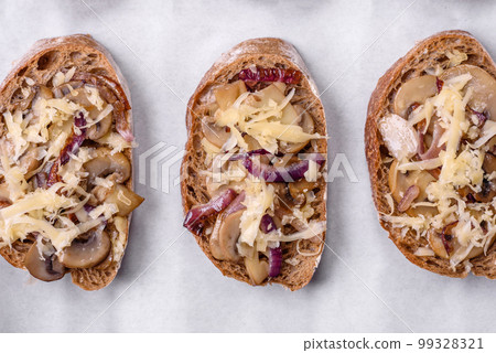 Delicious crispy toast or bruschetta with fried onion, champignon mushrooms and cheese 99328321