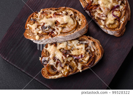 Delicious crispy toast or bruschetta with fried onion, champignon mushrooms and cheese 99328322