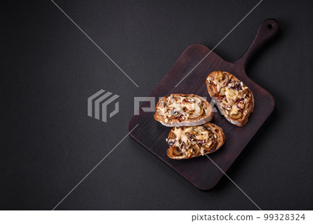 Delicious crispy toast or bruschetta with fried onion, champignon mushrooms and cheese 99328324