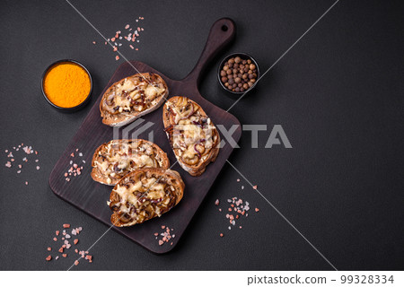 Delicious crispy toast or bruschetta with fried onion, champignon mushrooms and cheese Delicious crispy toast or bruschetta with fried onion, champignon mushrooms and cheese 99328334