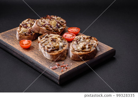 Delicious crispy toast or bruschetta with fried onion, champignon mushrooms and cheese Delicious crispy toast or bruschetta with fried onion, champignon mushrooms and cheese 99328335