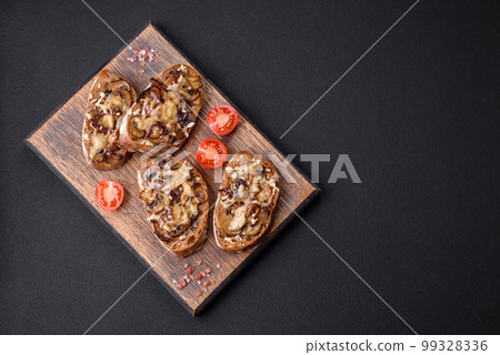 Delicious crispy toast or bruschetta with fried onion, champignon mushrooms and cheese Delicious crispy toast or bruschetta with fried onion, champignon mushrooms and cheese 99328336