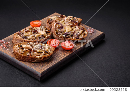 Delicious crispy toast or bruschetta with fried onion, champignon mushrooms and cheese 99328338