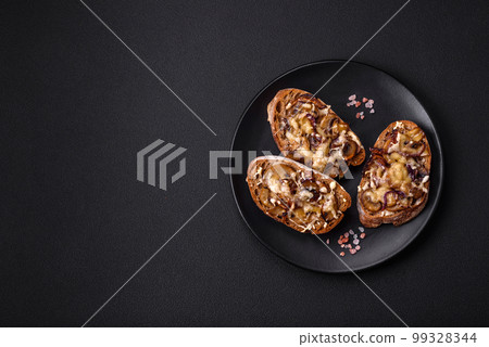 Delicious crispy toast or bruschetta with fried onion, champignon mushrooms and cheese Delicious crispy toast or bruschetta with fried onion, champignon mushrooms and cheese 99328344