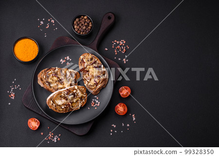 Delicious crispy toast or bruschetta with fried onion, champignon mushrooms and cheese Delicious crispy toast or bruschetta with fried onion, champignon mushrooms and cheese 99328350