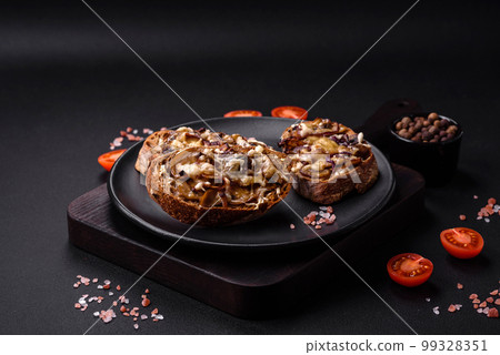Delicious crispy toast or bruschetta with fried onion, champignon mushrooms and cheese Delicious crispy toast or bruschetta with fried onion, champignon mushrooms and cheese 99328351