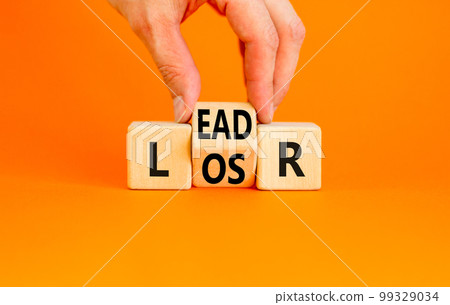 Leader or loser symbol. Concept word Leader Loser on wooden cubes. Beautiful orange table orange background. Businessman hand. Business and leader or loser concept. Copy space. 99329034