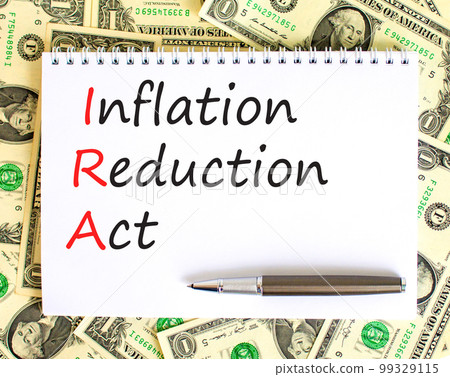 IRA inflation reduction act symbol. Concept words IRA inflation reduction act on white note on a beautiful background from dollar bills. Business IRA inflation reduction act concept. Copy space. IRA inflation reduction act symbol. Concept words IRA inflation reduction act on white note on a beautiful background from dollar bills. Business IRA inflation reduction act concept. Copy space. 99329115