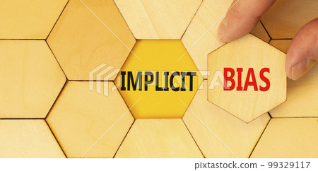 Implicit bias symbol. Concept words Implicit bias on wooden puzzles. Beautiful yellow table yellow background. Businessman hand. Business psychology implicit bias concept. Copy space. Implicit bias symbol. Concept words Implicit bias on wooden puzzles. Beautiful yellow table yellow background. Businessman hand. Business psychology implicit bias concept. Copy space. 99329117