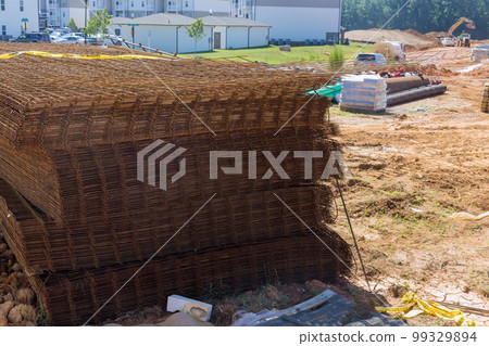 During construction process steel rod bars are used reinforcing concrete iron to create base structures for building. 99329894
