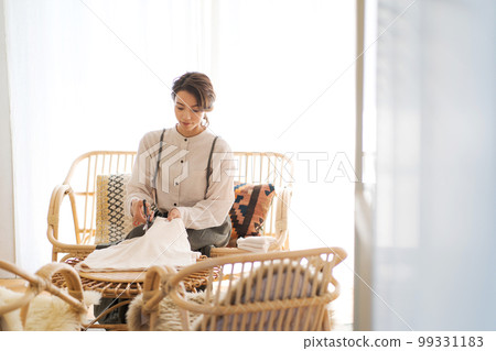 Photo of a woman reusing old towels Photo of a woman reusing old towels 99331183