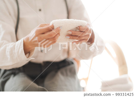 Photo of a woman reusing old towels Photo of a woman reusing old towels 99331425