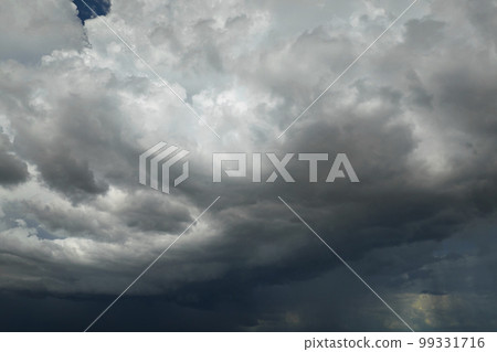 Landscape of dark ominous clouds forming on stormy sky during heavy thunderstorm 99331716