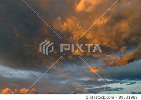 Cumulonimbus clouds forming before thunderstorm on evening sky. Changing stormy cloudscape weather at sunset 99331962