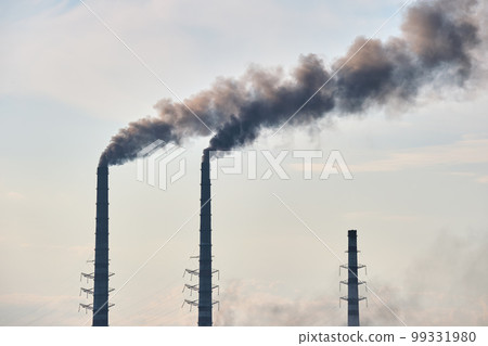 Coal power plant high pipes with black smoke moving upwards polluting atmosphere. Production of electrical energy with fossil fuel concept 99331980