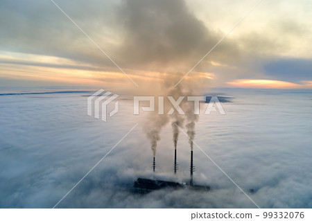 Coal power plant high pipes with black smoke moving upwards polluting atmosphere. Production of electrical energy with fossil fuel concept 99332076