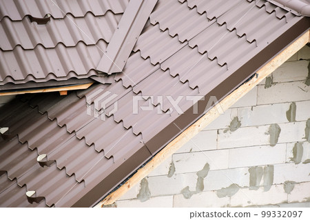 Closeup of house roof top covered with metallic shingles Closeup of house roof top covered with metallic shingles 99332097