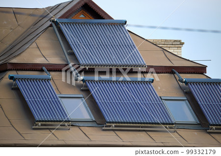 Building roof with rows of vacuum air solar collectors for water heating and producing of clean ecological energy. Renewable heat energy with zero emission Building roof with rows of vacuum air solar collectors for water heating and producing of clean ecological energy. Renewable heat energy with zero emission 99332179
