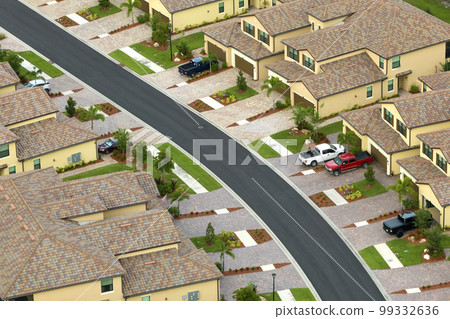Aerial view of tightly located family houses in Florida closed suburban area. Real estate development in american suburbs 99332636
