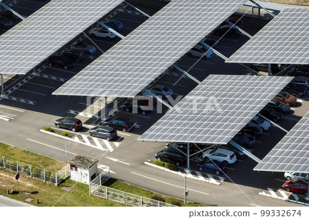 Aerial view of solar panels installed over parking lot with parked cars for effective generation of clean energy 99332674