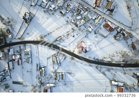 Aerial view of private homes with snow covered roofs in rural suburbs town area in cold winter 99332736