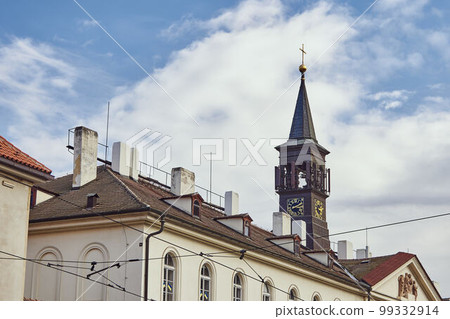 Clock on church tower in Prague against the sky. Clock on church tower in Prague against the sky. 99332914